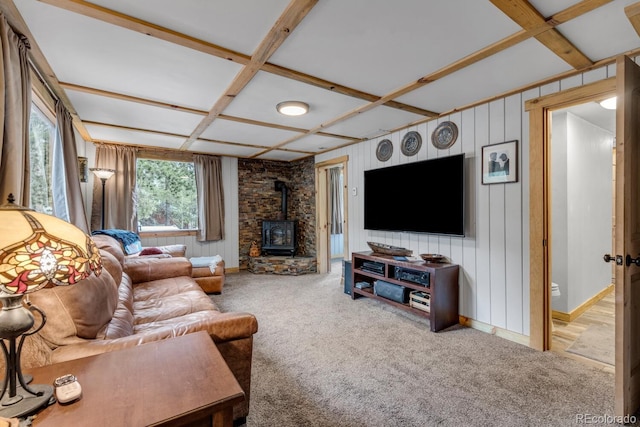 146 Dynamite Dr, Black Hawk, CO 80422 - carpeted living area with a wood stove, coffered ceiling, wooden walls, beam ceiling, and baseboards