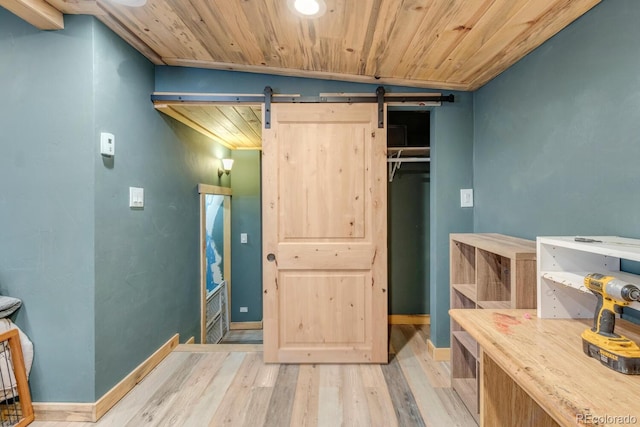 146 Dynamite Dr, Black Hawk, CO 80422 - bedroom featuring wooden ceiling, a barn door, light wood-style flooring, and baseboards