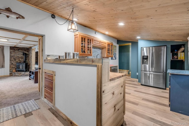 146 Dynamite Dr, Black Hawk, CO 80422 - kitchen with stainless steel refrigerator with ice dispenser, wood ceiling, a wood stove, glass insert cabinets, and recessed lighting