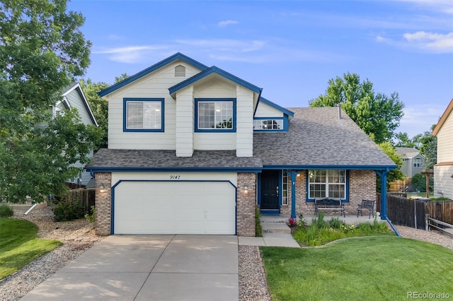 9147 W Rockland Pl, Littleton, CO 80128 - view of front facade with brick siding, a shingled roof, a garage, and driveway