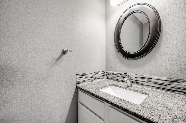 9147 W Rockland Pl, Littleton, CO 80128 - bathroom with a textured wall, vanity, and backsplash