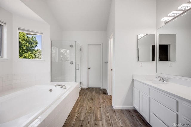 9147 W Rockland Pl, Littleton, CO 80128 - bathroom with vanity, a garden tub, a stall shower, and wood finished floors