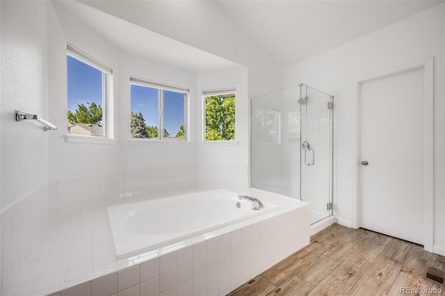 9147 W Rockland Pl, Littleton, CO 80128 - bathroom with a garden tub, a stall shower, and wood finished floors