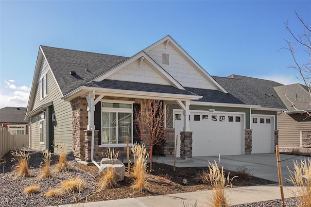 craftsman inspired home featuring stone siding, driveway, a garage, and roof with shingles