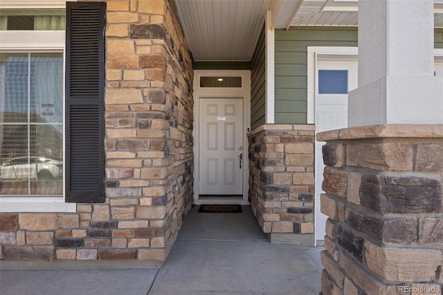 view of exterior entry featuring stone siding