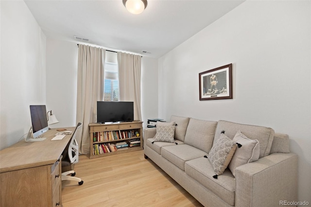 living area with light wood finished floors and visible vents