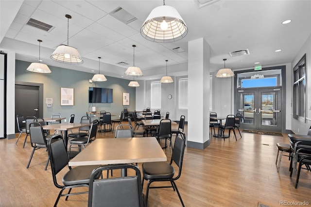 dining area featuring light wood-style floors and visible vents