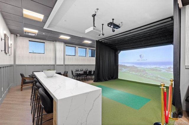 recreation room with golf simulator and wood finished floors