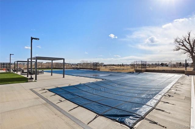 view of pool featuring fence