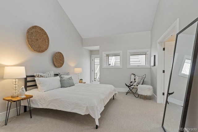 carpeted bedroom featuring high vaulted ceiling