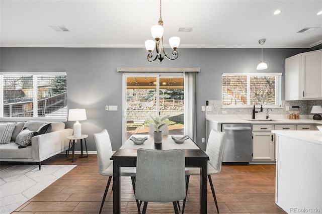 dining space with a wealth of natural light, dark wood-style flooring, and visible vents