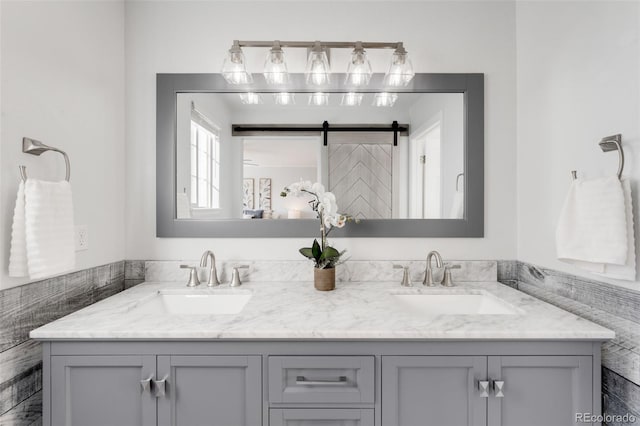 bathroom featuring a sink and double vanity