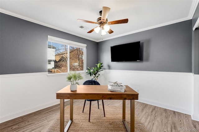 home office featuring crown molding, ceiling fan, baseboards, and wood finished floors