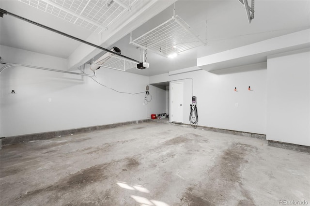 parking deck with baseboards and a garage door opener