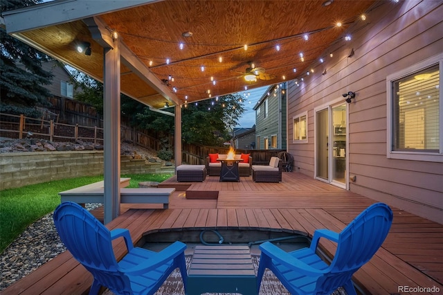 wooden terrace with a fenced backyard and an outdoor living space