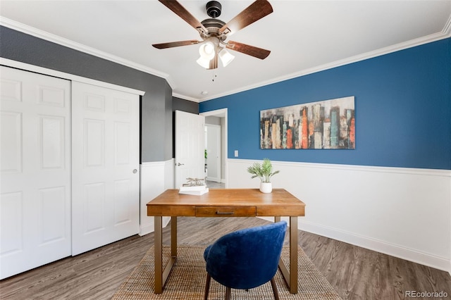 office space with ornamental molding, wainscoting, wood finished floors, and a ceiling fan