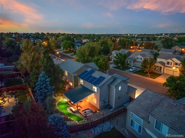 aerial view at dusk featuring a residential view