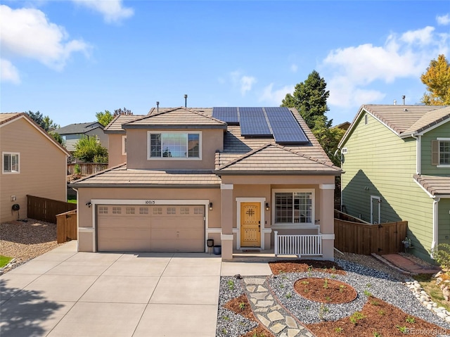 view of front of house with fence, solar panels, and stucco siding