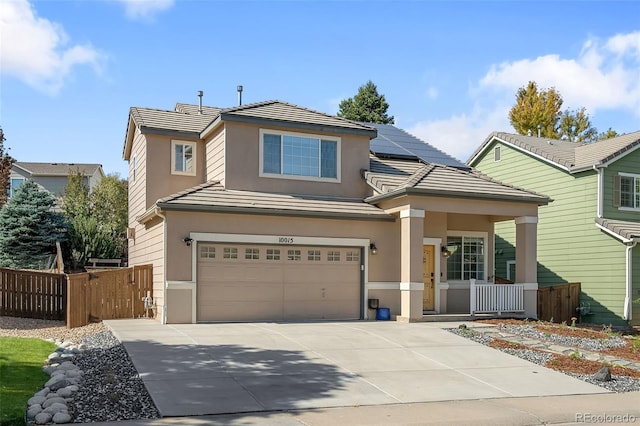 view of front facade featuring driveway, solar panels, an attached garage, fence, and stucco siding