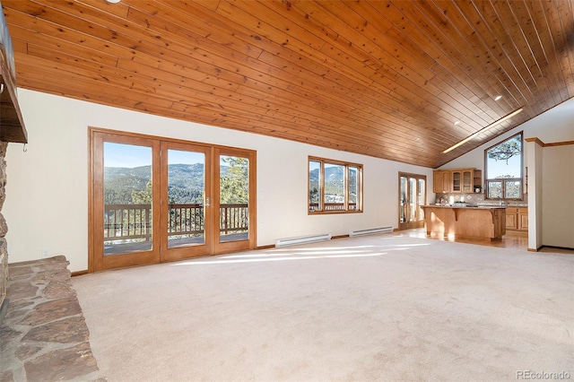 unfurnished living room featuring a baseboard radiator, high vaulted ceiling, a mountain view, light carpet, and wood ceiling