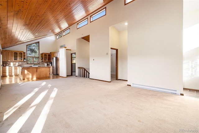 unfurnished living room with light colored carpet, high vaulted ceiling, baseboard heating, and wooden ceiling