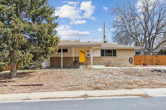 single story home with brick siding and fence