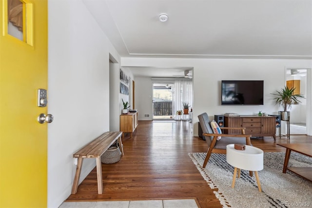 living room featuring a ceiling fan and wood finished floors