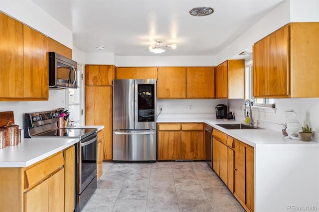 kitchen featuring appliances with stainless steel finishes, brown cabinetry, and a sink