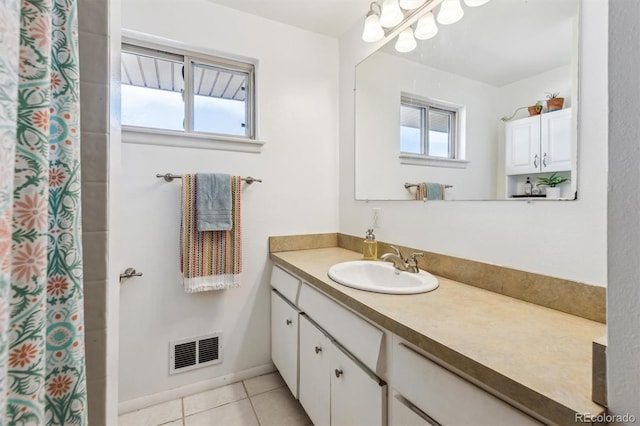 bathroom featuring vanity, a wealth of natural light, tile patterned flooring, and visible vents