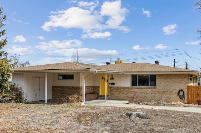 ranch-style house with brick siding and fence