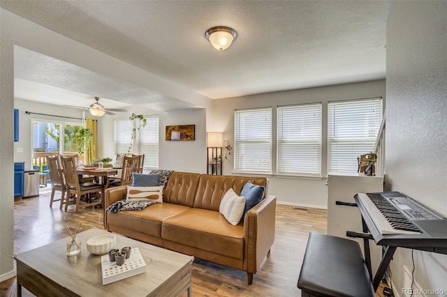 533 Horizon Pl, Dacono, CO 80514 - living room with wood finished floors, ceiling fan, and a textured wall