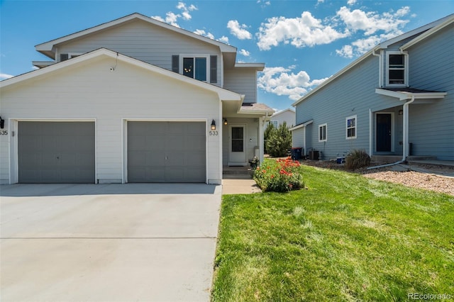533 Horizon Pl, Dacono, CO 80514 - view of front of home with concrete driveway, an attached garage, and a front lawn