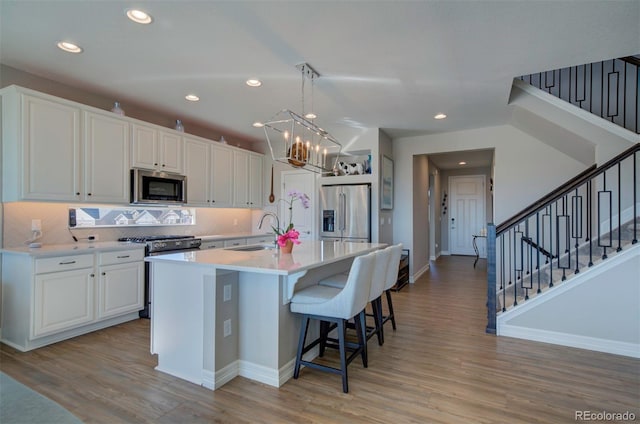 kitchen featuring white cabinetry, appliances with stainless steel finishes, and a sink