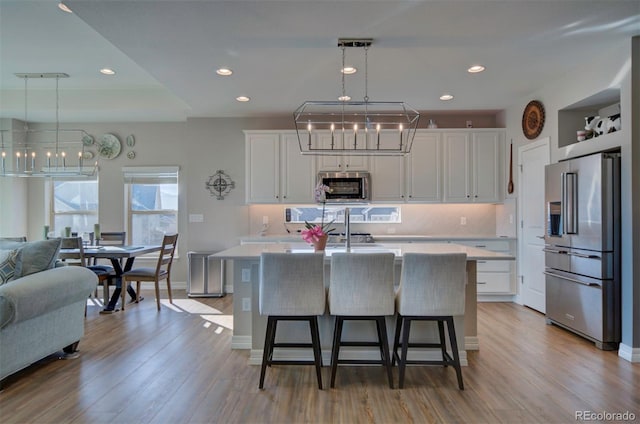 kitchen featuring a notable chandelier, appliances with stainless steel finishes, and light countertops