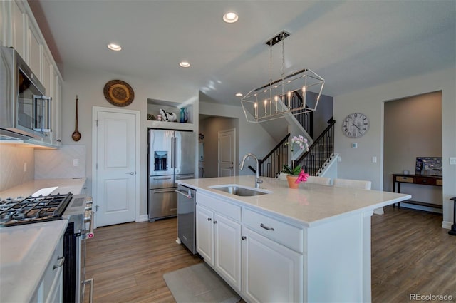 kitchen with recessed lighting, a sink, dark wood-type flooring, appliances with stainless steel finishes, and white cabinetry