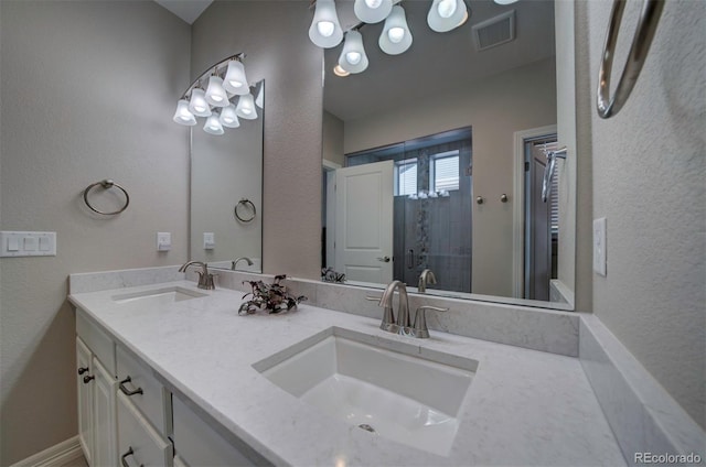 bathroom with a shower stall, double vanity, visible vents, and a sink