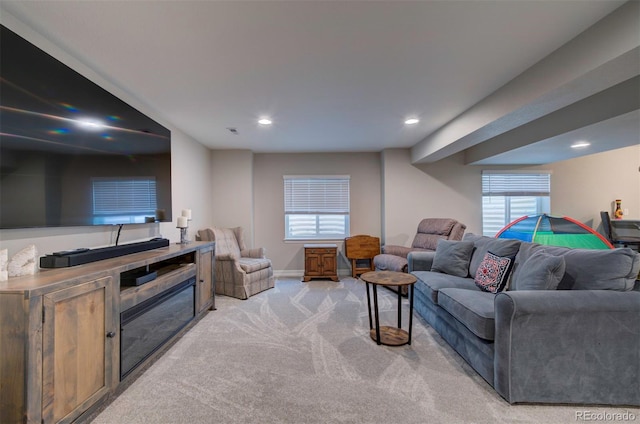 living area with recessed lighting, light colored carpet, and baseboards