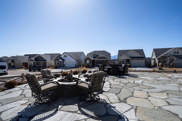 view of patio / terrace with a residential view and a fire pit