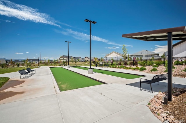 view of property's community with a residential view and fence