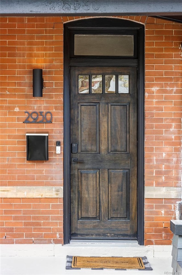 property entrance featuring brick siding