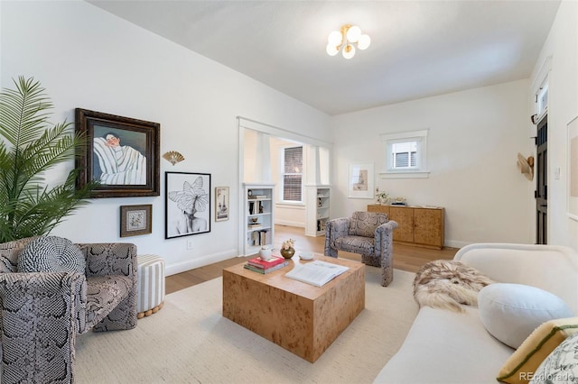 living room with baseboards and light wood finished floors