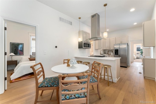 dining area featuring baseboards, recessed lighting, light wood-style flooring, and visible vents