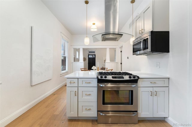 kitchen with light wood-style floors, light countertops, stainless steel appliances, baseboards, and island exhaust hood