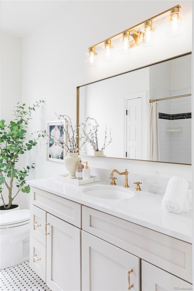 bathroom with double vanity, toilet, a shower with curtain, and a sink