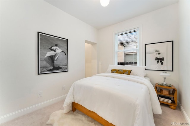 carpeted bedroom featuring baseboards