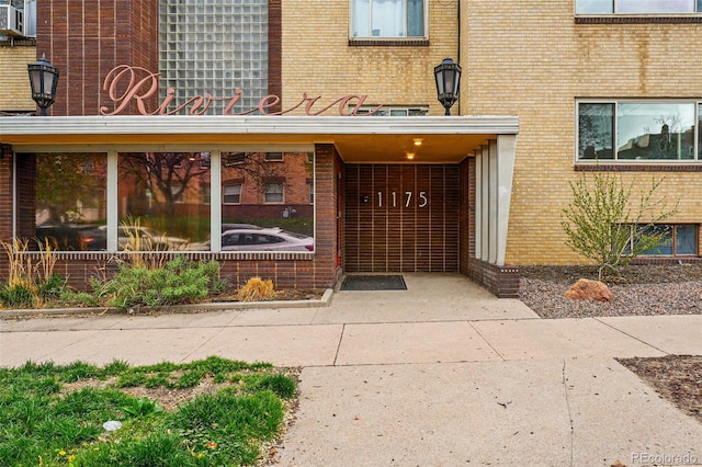 view of exterior entry with brick siding