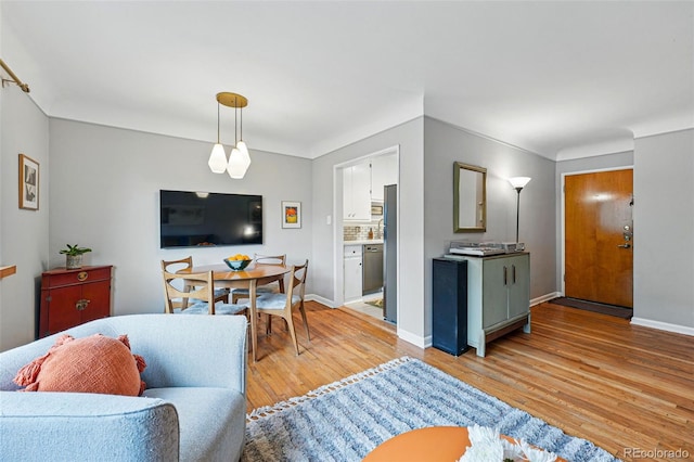living room featuring light wood-style floors and baseboards