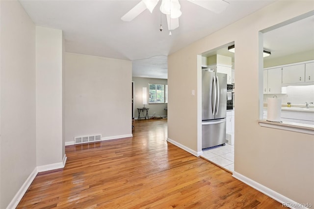 8250 Chase Way, Arvada, CO 80003 - unfurnished room featuring ceiling fan and light wood-type flooring