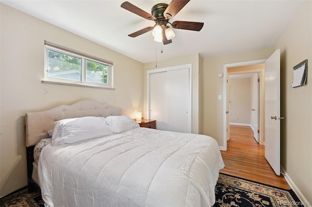8250 Chase Way, Arvada, CO 80003 - bedroom with wood finished floors, ceiling fan, and a closet