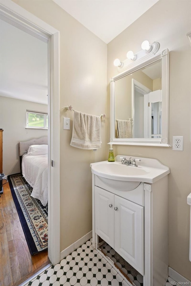 8250 Chase Way, Arvada, CO 80003 - bathroom featuring vanity and baseboards